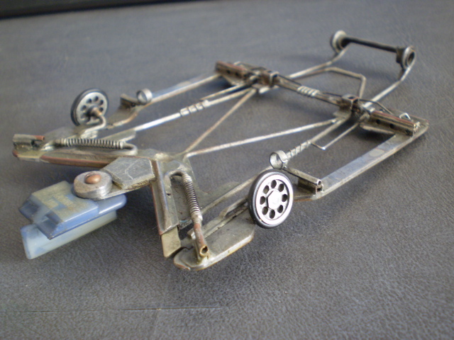 Hand drilled 1/2" fronts and guide secured by a machined collar and a screw through the post. Body was the Sunset "Le Mans " coupe. Soldered motor springs were lead wire retainers.